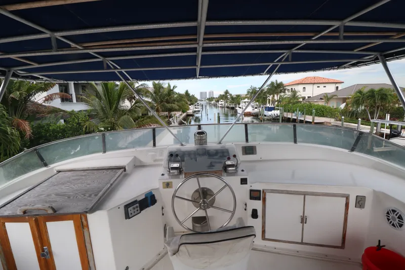 Slide: The Image of Cockpit view of 1988 Jefferson Marquessa 60 MY yacht, overlooking a scenic canal. - 9