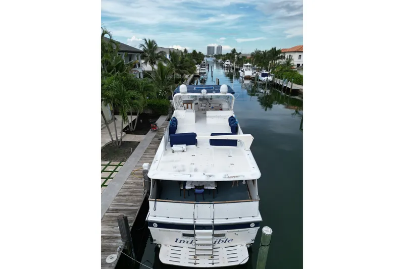 Slide: The Image of 1988 Jefferson Marquessa 60 MY yacht docked in a scenic canal with palm trees. - 7