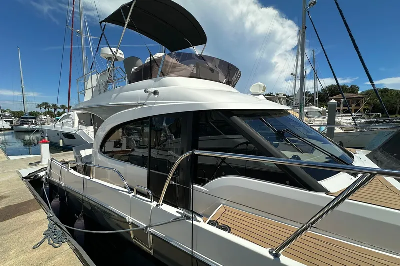 Slide: The Image of 2024 Beneteau Antares 11 Fly yacht docked at marina under clear blue sky. - 9