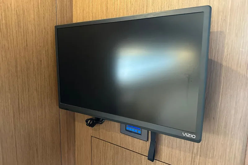Slide: The Image of Vizio TV mounted on wooden panel inside 2024 Beneteau Antares 11 Fly yacht. - 89