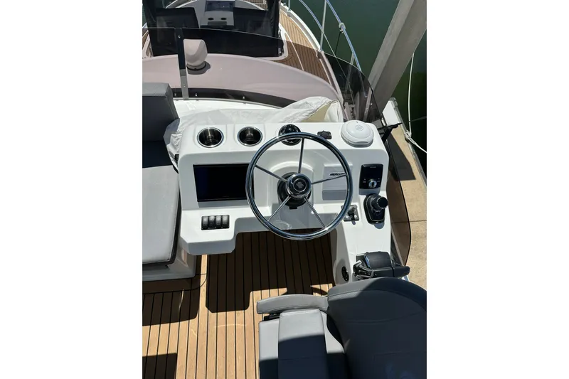 Slide: The Image of 2024 Beneteau Antares 11 Fly helm with modern controls and sleek design. - 26