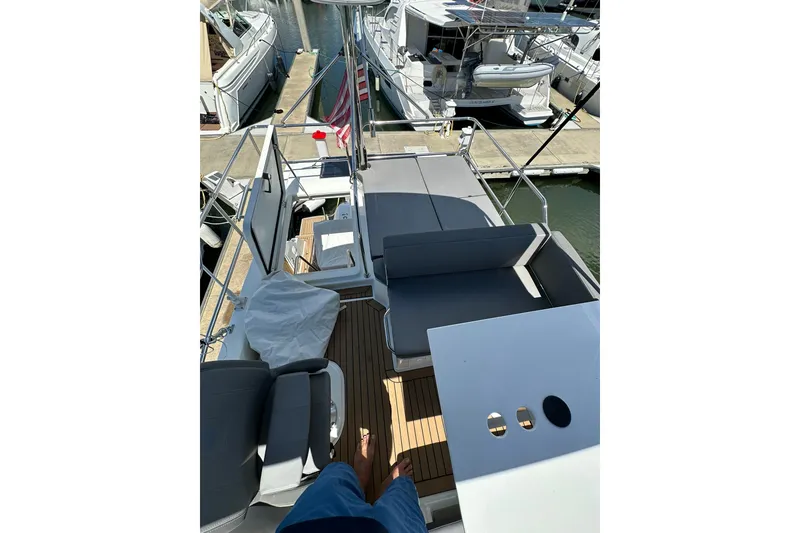 Slide: The Image of 2024 Beneteau Antares 11 Flybridge with seating area, docked at marina. - 23