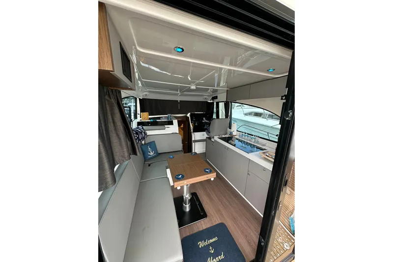 Slide: The Image of Interior of 2024 Beneteau Antares 11 Fly, featuring modern seating and kitchenette. - 44
