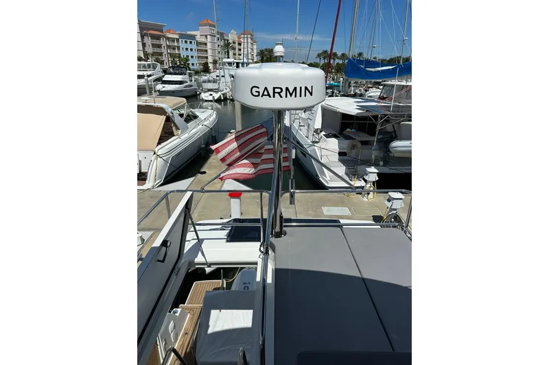 Slide: The Image of 2024 Beneteau Antares 11 Fly at marina, featuring Garmin equipment and American flag. - 30