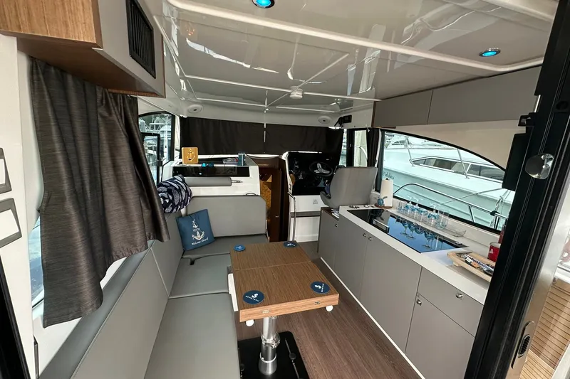 Slide: The Image of Interior of 2024 Beneteau Antares 11 Fly, featuring modern seating and kitchenette. - 43