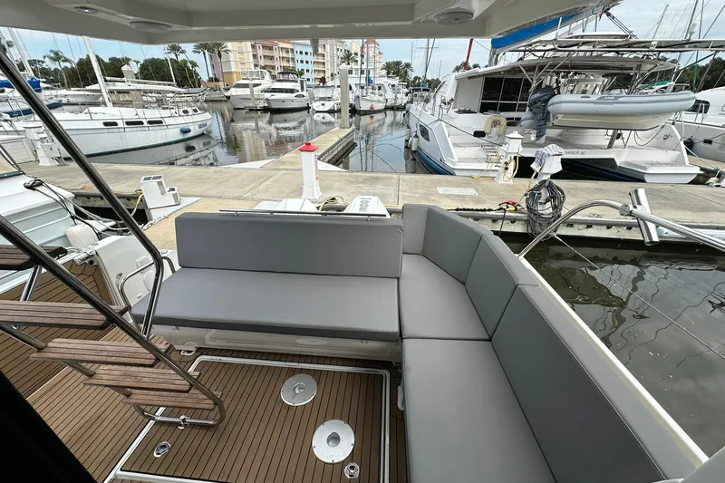 Slide: The Image of 2024 Beneteau Antares 11 Fly yacht interior with sleek seating at marina. - 17