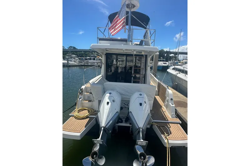 Slide: The Image of 2024 Beneteau Antares 11 Fly yacht docked with dual outboard engines. - 7