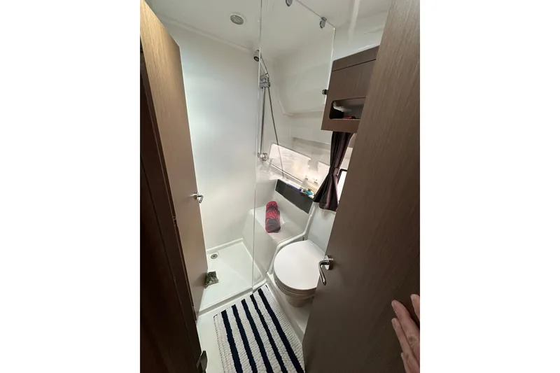 Slide: The Image of Compact bathroom in 2024 Beneteau Antares 11 Fly yacht, featuring shower and toilet. - 40