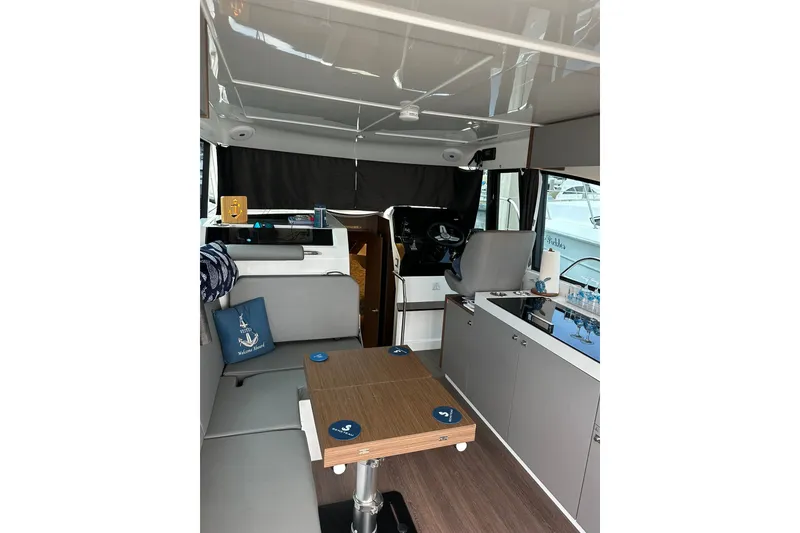 Slide: The Image of Interior of 2024 Beneteau Antares 11 Fly, featuring modern seating and table setup. - 45