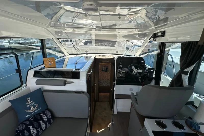 Slide: The Image of Interior of 2024 Beneteau Antares 11 Fly, featuring helm and seating area. - 59