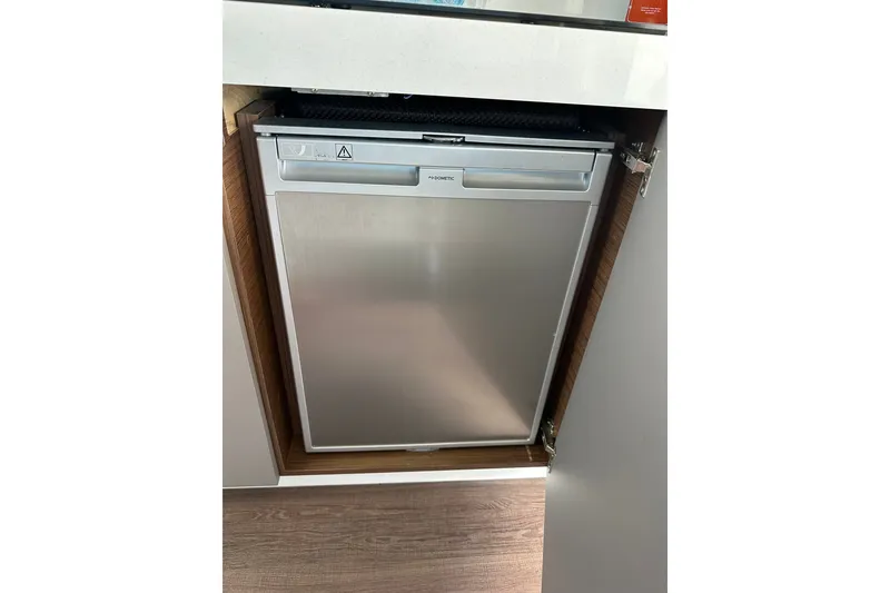 Slide: The Image of Built-in refrigerator on 2024 Beneteau Antares 11 Fly yacht, sleek and modern design. - 63