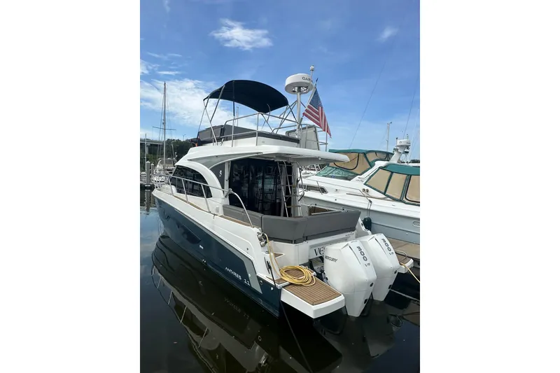 Slide: The Image of 2024 Beneteau Antares 11 Fly yacht docked, featuring dual Mercury engines and flybridge. - 2
