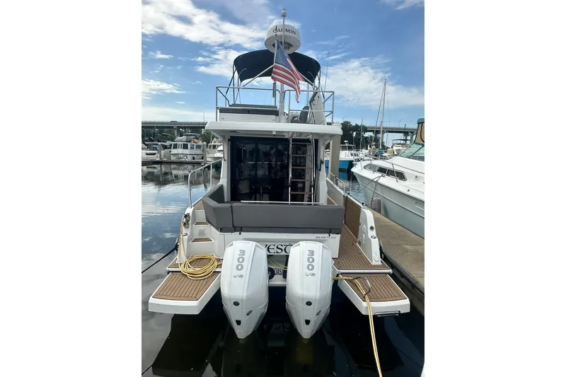 Slide: The Image of 2024 Beneteau Antares 11 Fly yacht docked, featuring twin 300 horsepower engines. - 3