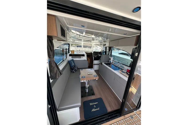 Slide: The Image of Interior view of 2024 Beneteau Antares 11 Fly, showcasing modern seating and kitchen area. - 54