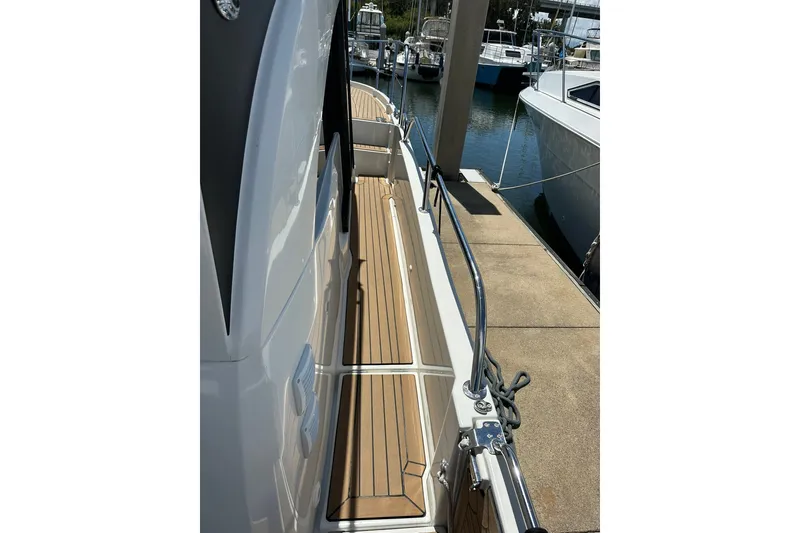 Slide: The Image of 2024 Beneteau Antares 11 Fly yacht docked, showcasing sleek deck design and railing. - 21