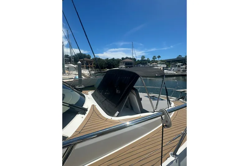 Slide: The Image of 2024 Beneteau Antares 11 Fly yacht docked, showcasing sleek design and spacious deck. - 8
