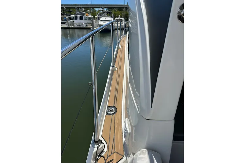 Slide: The Image of Side deck view of 2024 Beneteau Antares 11 Fly, showcasing sleek design and railing. - 20