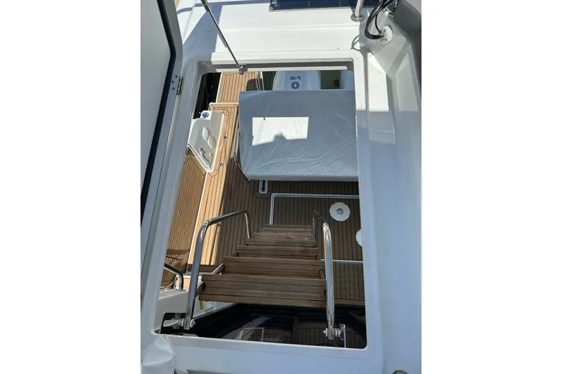 Slide: The Image of 2024 Beneteau Antares 11 Fly yacht interior with wooden stairs and deck view. - 31