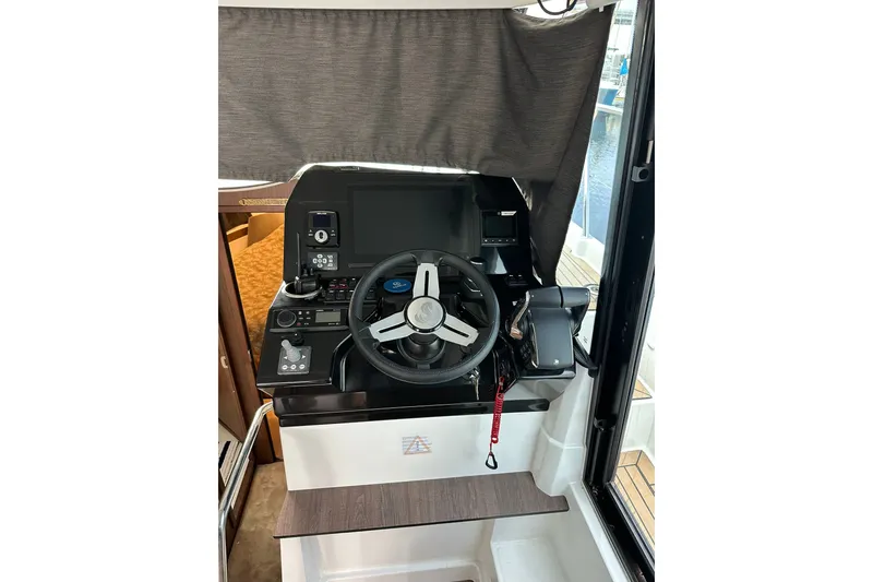 Slide: The Image of 2024 Beneteau Antares 11 Fly helm station with modern controls and steering wheel. - 36