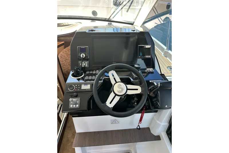 Slide: The Image of Helm of 2024 Beneteau Antares 11 Fly with modern controls and navigation equipment. - 64