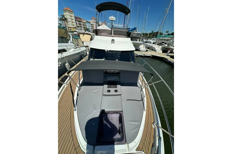 Slide: The Image of 2024 Beneteau Antares 11 Fly yacht docked at marina, showcasing sleek design and spacious deck. - 12