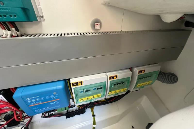 Slide: The Image of Electrical panel inside 2024 Beneteau Antares 11 Fly boat, featuring wiring and circuit components. - 52