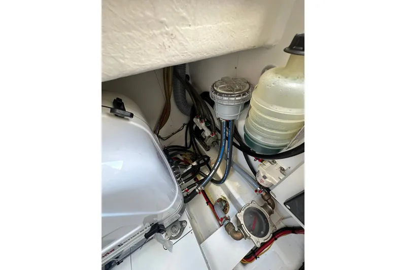 Slide: The Image of Engine compartment of 2024 Beneteau Antares 11 Fly with visible components and wiring. - 53