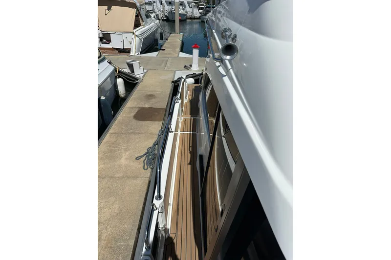 Slide: The Image of 2024 Beneteau Antares 11 Fly docked, showcasing sleek side deck and modern design. - 19