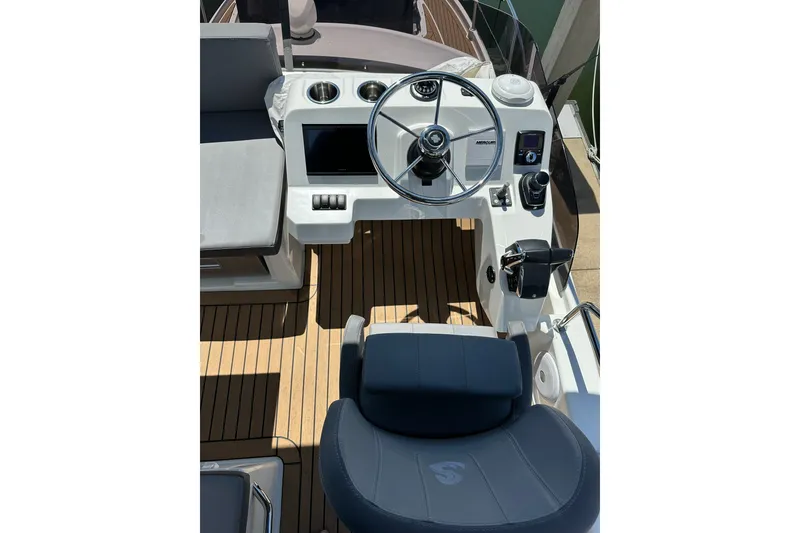 Slide: The Image of 2024 Beneteau Antares 11 Fly helm with modern controls and teak flooring. - 27