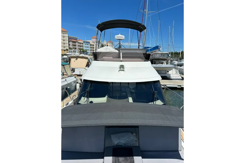 Slide: The Image of 2024 Beneteau Antares 11 Fly yacht docked in a marina, showcasing sleek design and modern features. - 13