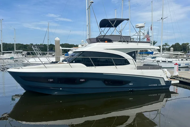 Slide: The Image of 2024 Beneteau Antares 11 Fly yacht docked at a marina, side view. - 1
