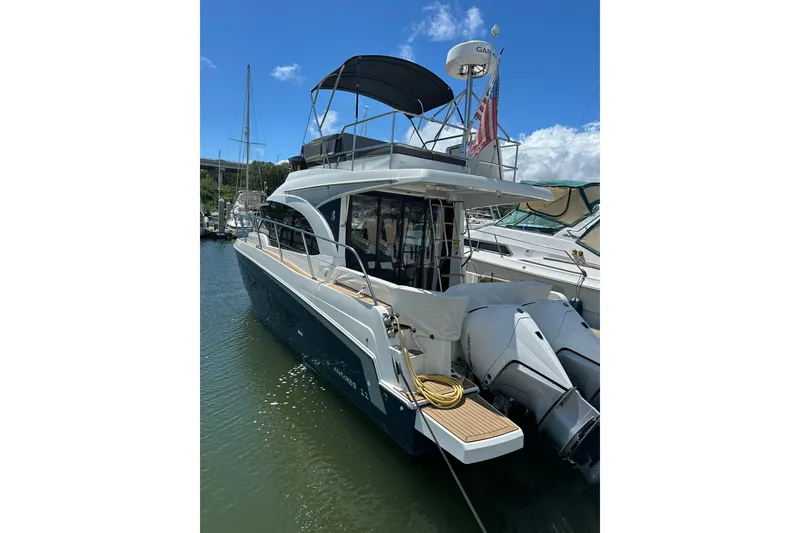 Slide: The Image of 2024 Beneteau Antares 11 Fly yacht docked in marina, featuring dual outboard engines. - 6