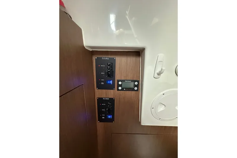 Slide: The Image of Control panel inside 2024 Beneteau Antares 11 Fly, featuring modern switches and digital displays. - 42