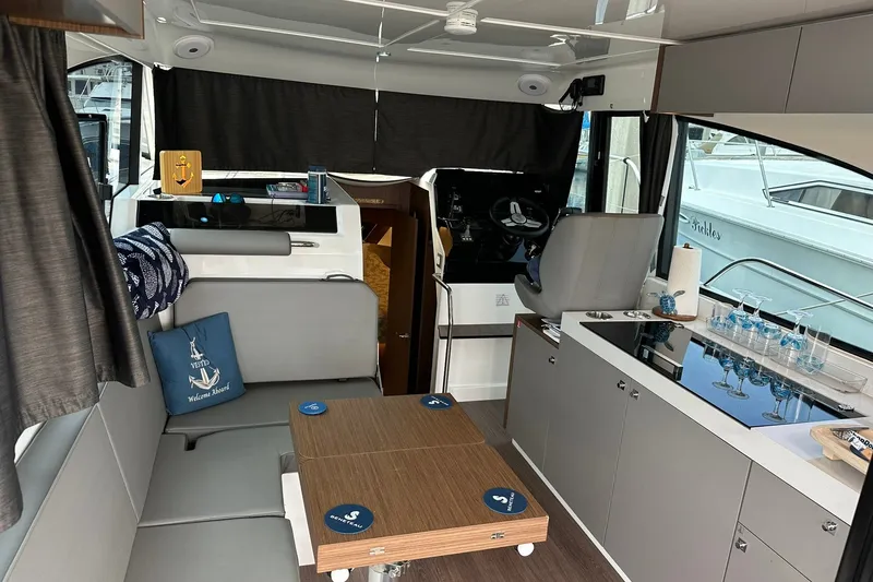 Slide: The Image of Interior of 2024 Beneteau Antares 11 Fly, featuring modern seating and kitchenette. - 46
