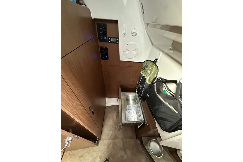 Slide: The Image of Interior of 2024 Beneteau Antares 11 Fly, featuring storage and control panels. - 41