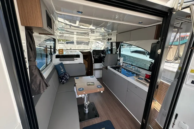 Slide: The Image of Interior of 2024 Beneteau Antares 11 Fly, featuring modern seating and kitchenette. - 55