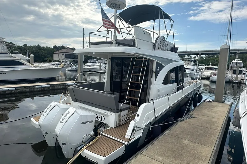 Slide: The Image of 2024 Beneteau Antares 11 Fly yacht docked at marina with twin Mercury engines. - 5