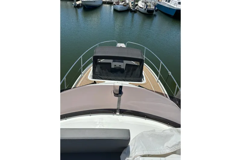 Slide: The Image of 2024 Beneteau Antares 11 Fly yacht, view from flybridge, docked in marina. - 28