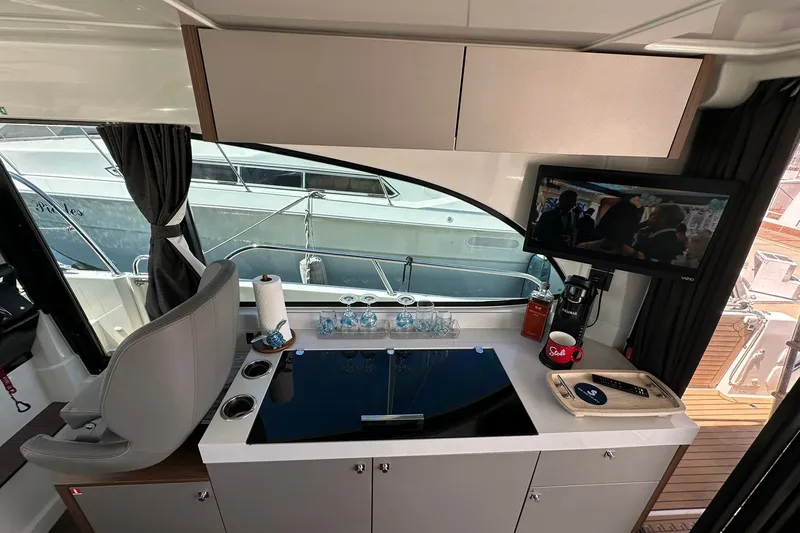 Slide: The Image of Interior of 2024 Beneteau Antares 11 Fly, featuring a modern kitchenette and entertainment area. - 61