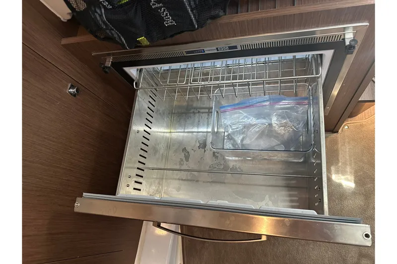 Slide: The Image of Open drawer refrigerator on 2024 Beneteau Antares 11 Fly yacht, showcasing interior storage space. - 79