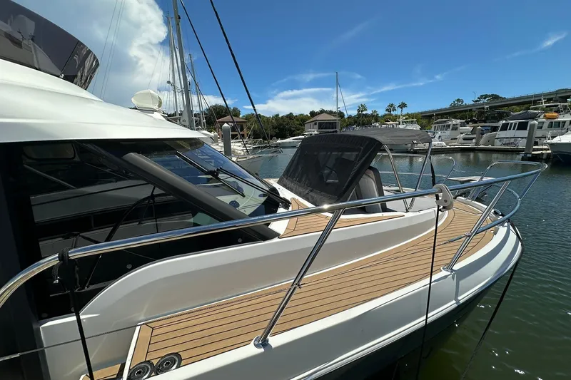 Slide: The Image of 2024 Beneteau Antares 11 Fly yacht docked in a marina under clear blue skies. - 10