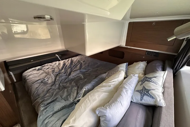Slide: The Image of Cozy cabin interior of 2024 Beneteau Antares 11 Fly with plush bedding and starfish pillows. - 76