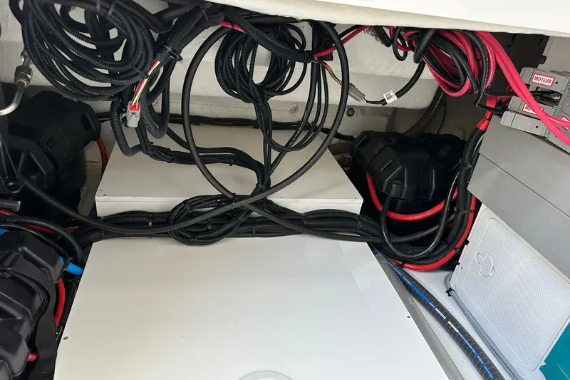 Slide: The Image of Engine compartment of 2024 Beneteau Antares 11 Fly with wiring and battery setup. - 48