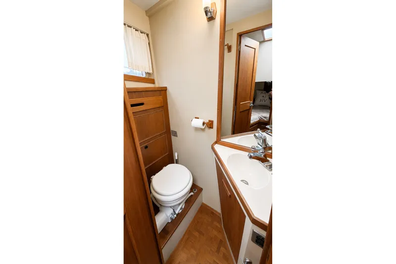 Slide: The Image of 1978 Grand Banks 36 Classic yacht bathroom with wooden cabinetry and compact design. - 28