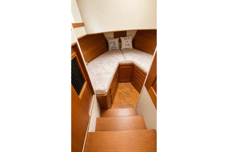 Slide: The Image of 1978 Grand Banks 36 Classic cabin interior with wooden finish and cozy bedding. - 23