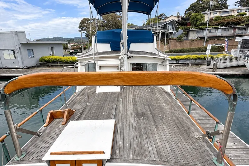 Slide: The Image of 1978 Grand Banks 36 Classic yacht docked, showcasing wooden deck and railing. - 7