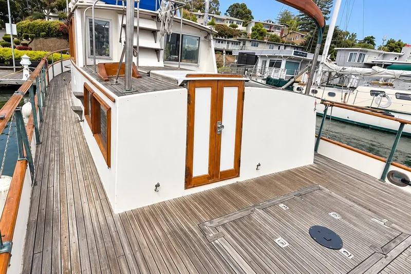 Slide: The Image of 1978 Grand Banks 36 Classic yacht deck with wooden accents and marina view. - 9
