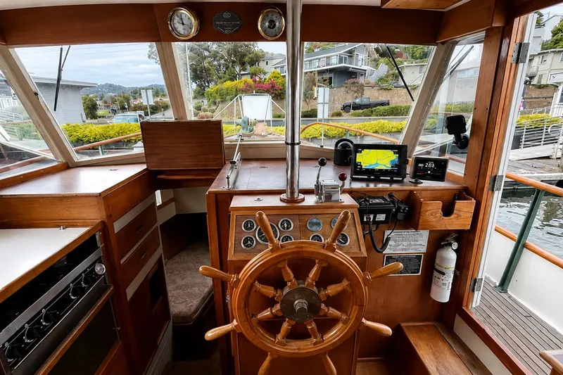 Slide: The Image of 1978 Grand Banks 36 Classic boat helm with wooden wheel and navigation instruments. - 11