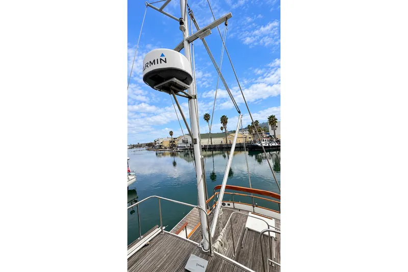 Slide: The Image of 1978 Grand Banks 36 Classic yacht with Garmin radar, docked in a serene marina. - 8