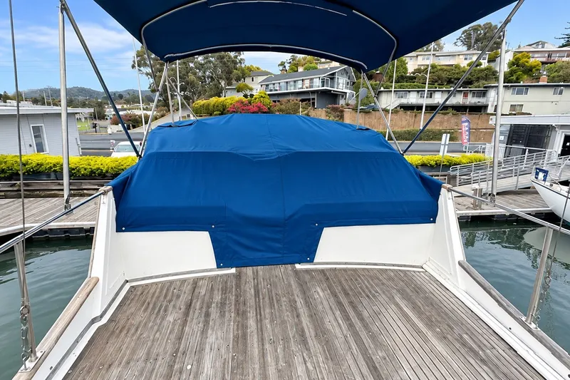 Slide: The Image of 1978 Grand Banks 36 Classic boat with blue cover at marina dock. - 4